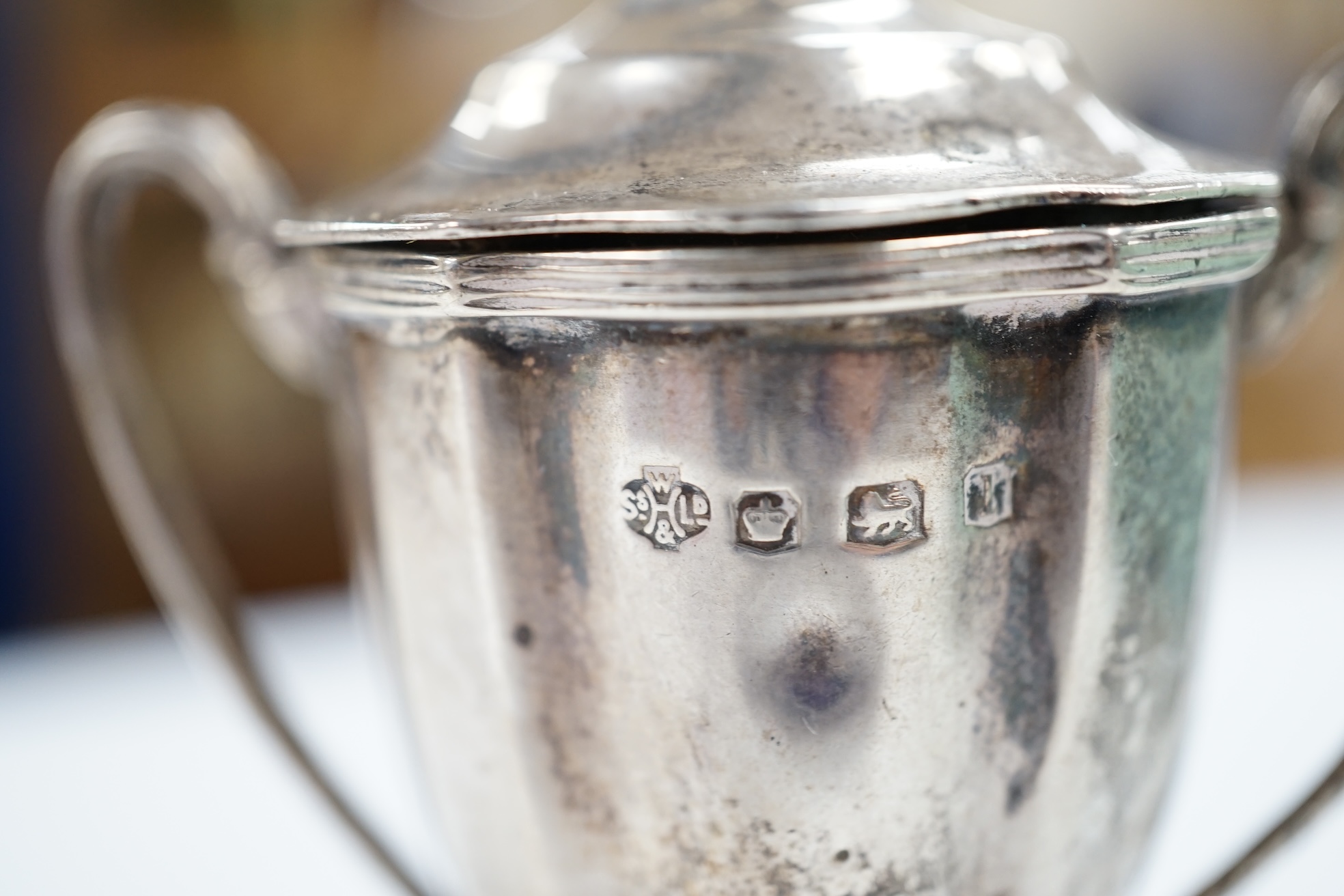 A collection of small silver collectables including a mounted hip flask, five napkin rings, two mounted toilet jars, trinket box, two wine labels, three condiments, a silver collar and a small trophy cup. Condition - poo